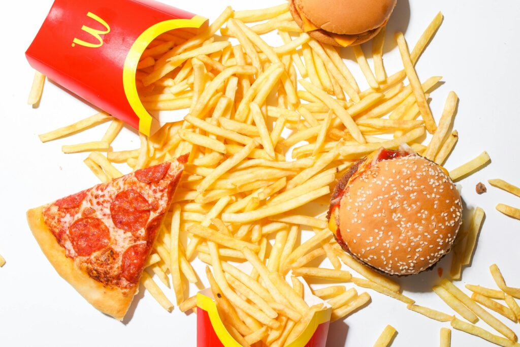 pexels-photo-4109256-4109256 A tantalizing spread of burger, fries, and pizza showcasing classic fast food indulgence.
